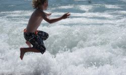 Termas da Azenha a-boy-jumps-in-the-waves-of-the-ocean